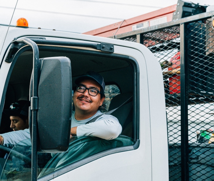 Hispanic man sitting in work truck